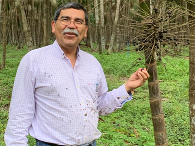 Professor Jose Fuentes holding a weather instrument